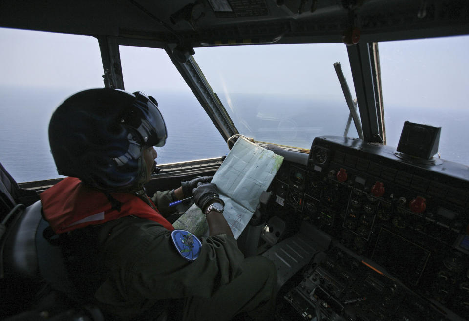 An Indonesian Navy pilot checks his map during a search operation for the missing Malaysian Airlines Boeing 777 over the waters bordering Indonesia, Malaysia and Thailand near the Malacca straits on Monday, March 10, 2014. Dozens of ships and aircraft have failed to find any piece of the missing Boeing 777 jet that vanished more than two days ago above waters south of Vietnam as investigators pursued "every angle" to explain its disappearance, including hijacking, Malaysia's civil aviation chief said Monday. (AP Photo/Binsar Bakkara)