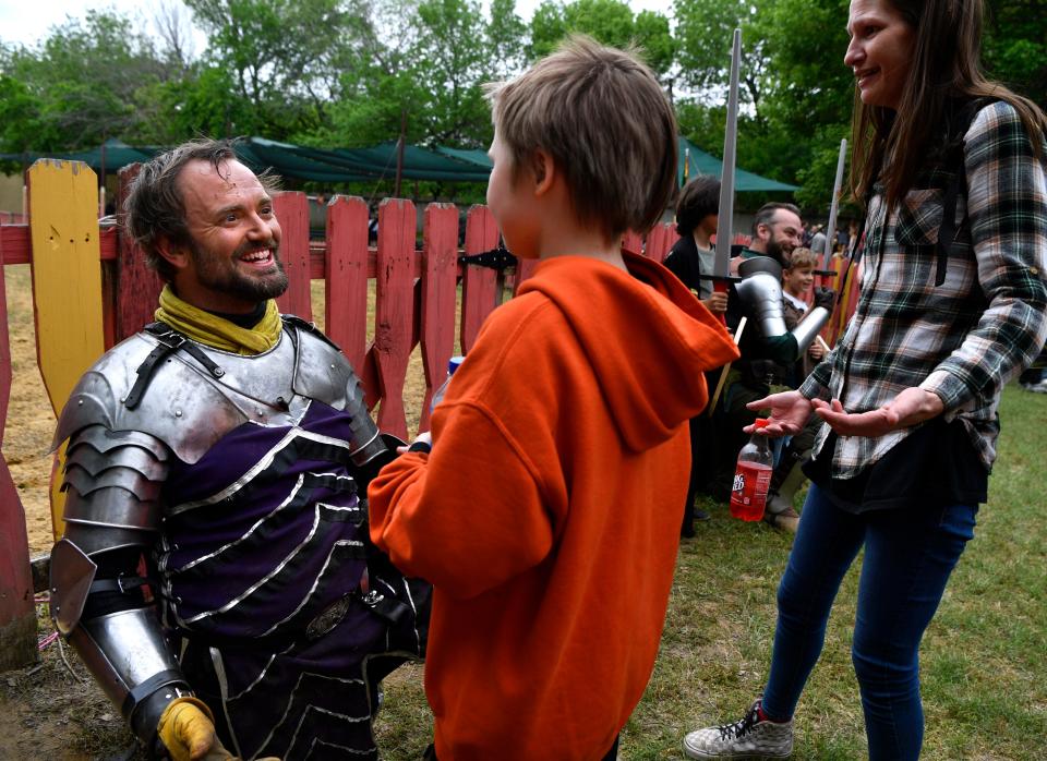 Chad “Lins” Wood, portraying Sir Logan after performing in a jousting match, greets a young admirer.