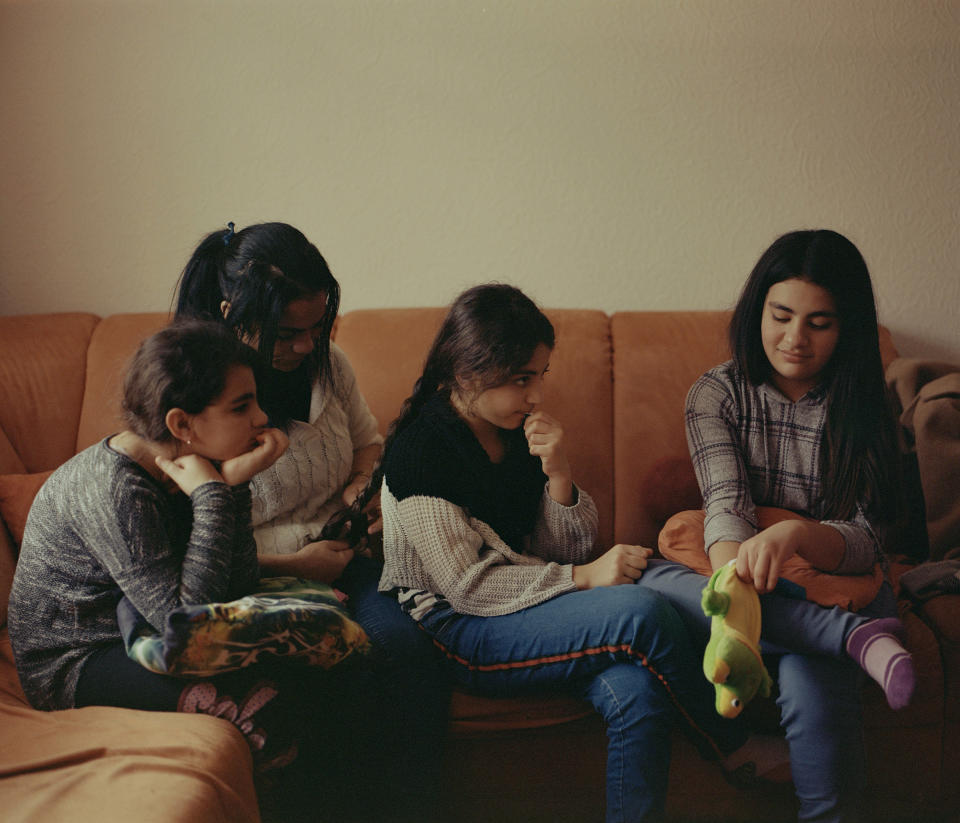 Hanan braiding her 11-year-old daughter Hanadi's hair while Berivan, 10 (L) and Haneya, 13 (R) watch.<span class="copyright">Tori Ferenc—INSTITUTE for TIME</span>