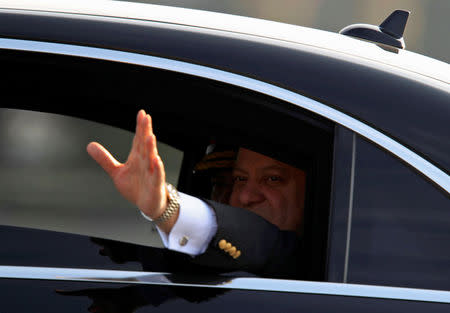 Pakistan's Prime Minister Nawaz Sharif waves from a vehicle as he arrives to attend the Pakistan Day military parade in Islamabad, Pakistan, March 23, 2017. REUTERS/Faisal Mahmood