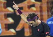 Switzerland's Roger Federer celebrates after defeating Australia's John Millman in their third round match at the Australian Open tennis championship in Melbourne, Australia, Saturday, Jan. 25, 2020.(AP Photo/Lee Jin-man)