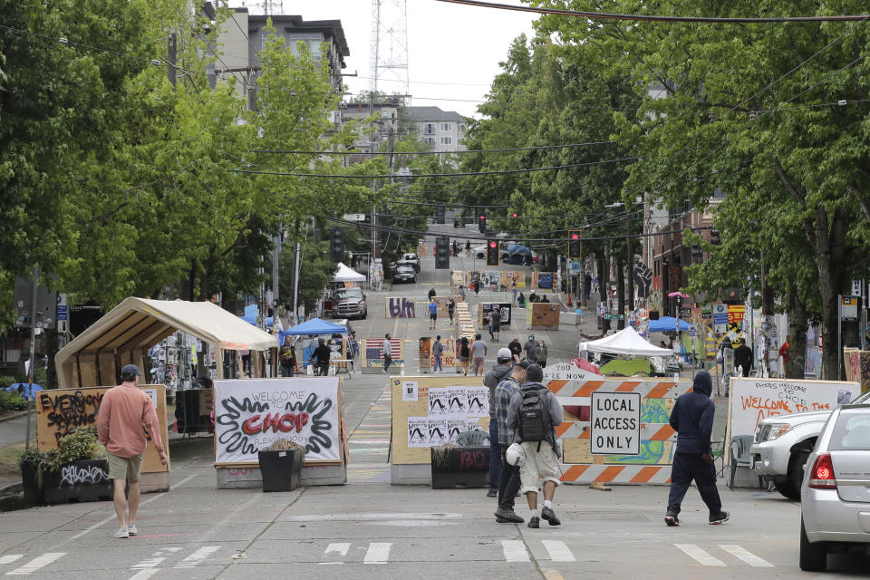 A sign on a barricade reads "Welcome to CHOP," Saturday, June 20, 2020, at the intersection of 10th Ave. and Pine St. at the Capitol Hill Occupied Protest zone in Seattle. A pre-dawn shooting near the area left one person dead and critically injured another person, authorities said Saturday. The area has been occupied by protesters after Seattle Police pulled back from several blocks of the city's Capitol Hill neighborhood near the Police Department's East Precinct building. (AP Photo/Ted S. Warren)