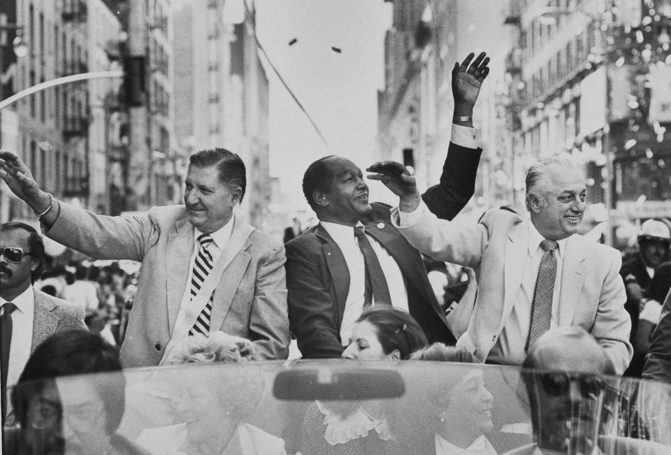 Al Campanis, left, vice president of player personnel for the Los Angeles Dodgers is joined by Mayor Tom Bradley and Dodgers manager Tom Lasorda during Dodger Day parade through the streets of Los Angeles, Oct. 31, 1981. More than 300,000 person lined the city sidewalks to acknowledge their appreciation of the 1981 World Series champions. (AP Photo/Randy Rasmussen)