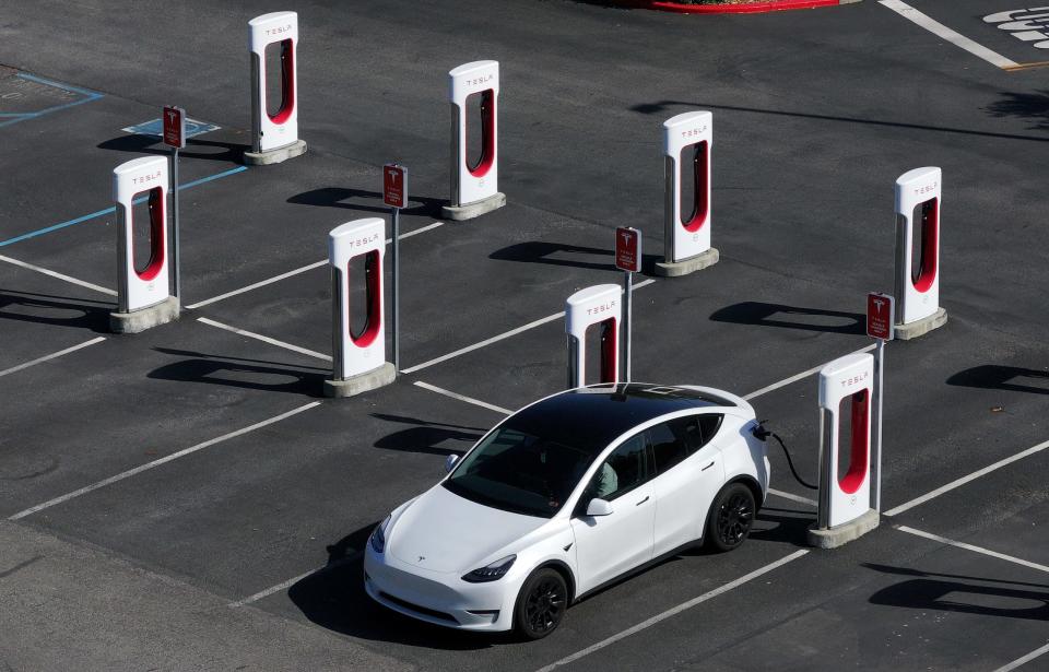 A Tesla car charging up at a Tesla Supercharger. - Copyright: Justin Sullivan via Getty Images