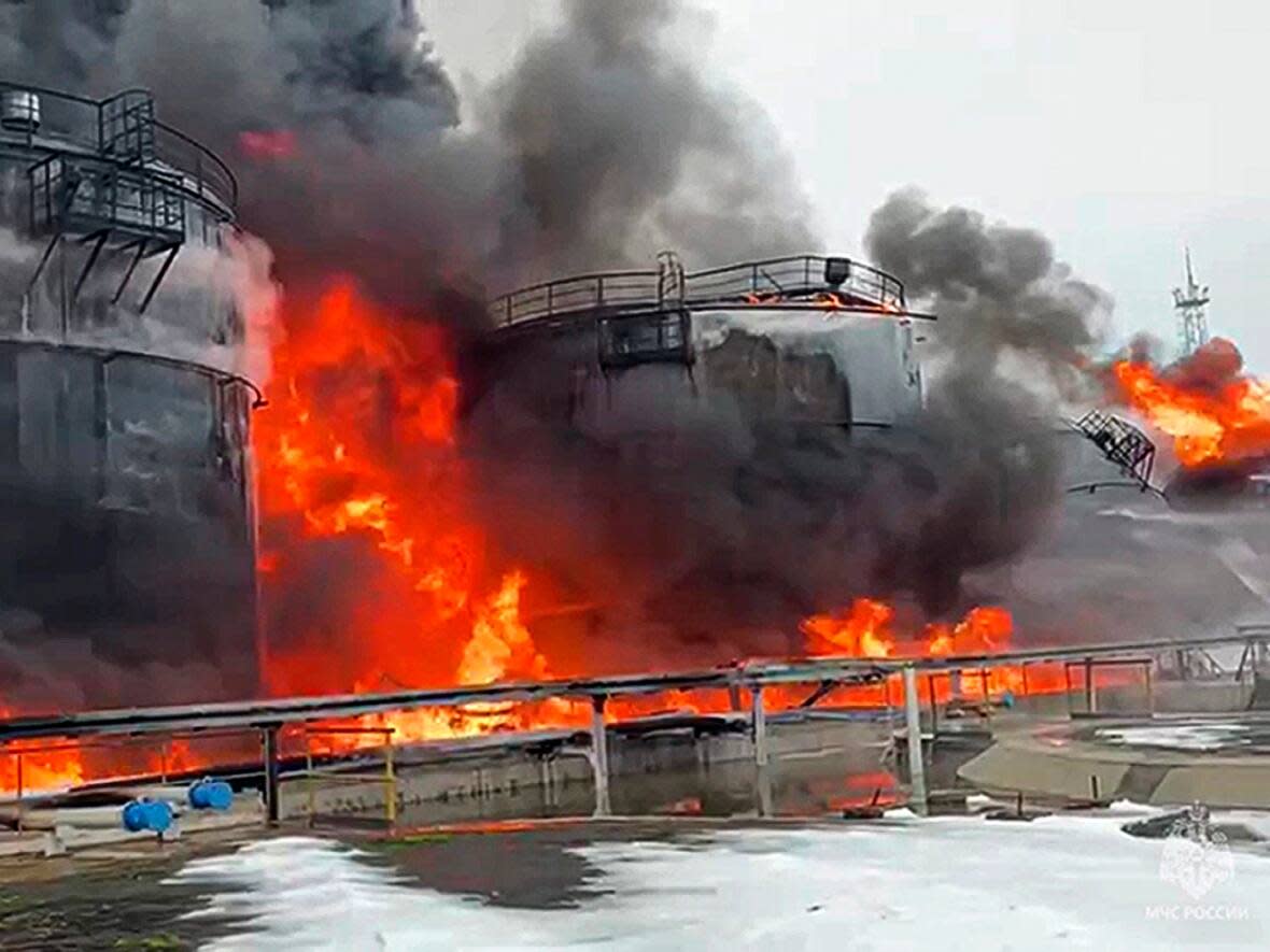 Bryansk Gov. Alexander Bogomaz shared a photo of oil tanks burning on Telegram on Feb. 19 after a reported drone attack on a facility in Klintsy, Russia. Analysts say the attacks show Ukraine may have an increased ability to strike targets deeper inside Russia.  (Bryansk Gov. Alexander Bogomaz/Telegram/The Associated Press - image credit)