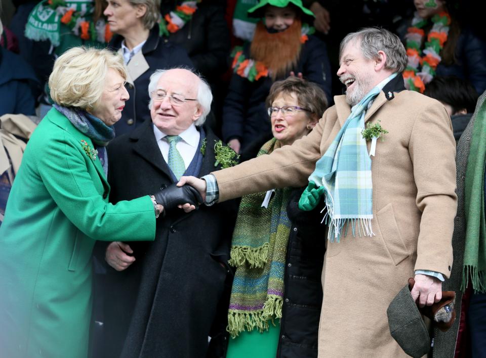 US actor Mark Hamill (R) shakes hands with Irish President Michael D Higgins (C) and his wife Sabrina (L) as he attends as international guest of honour during the St Patrick's Day parade in Dublin on March 16, 2018. / AFP PHOTO / Paul FAITH (Photo credit should read PAUL FAITH/AFP/Getty Images)