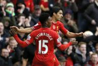 Liverpool's Luis Suarez (L) celebrates with teammate Daniel Sturridge after scoring a goal against Fulham during their English Premier League soccer match at Anfield in Liverpool, northern England November 9, 2013.
