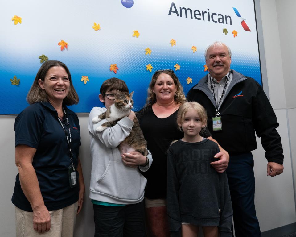Beth Bachus, left, Durango administrative assistant for American Airlines and Ed Lacy, right, Durango general manager for American Airlines, stand with Parker Wichert, Jeni Owens and Paylen Wichert after traveling with Sarin from Colorado to the Kansas City International Airport.