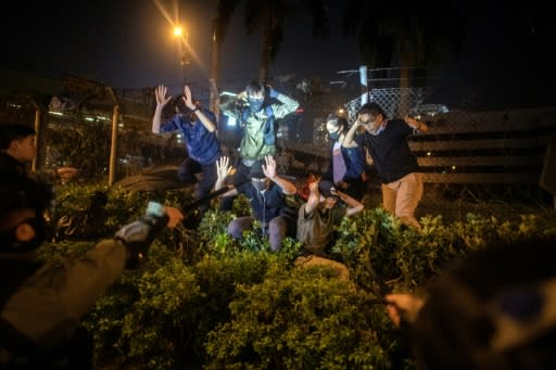 Police detain protesters and students after they tried to flee outside the Hong Kong Polytechnic University campus