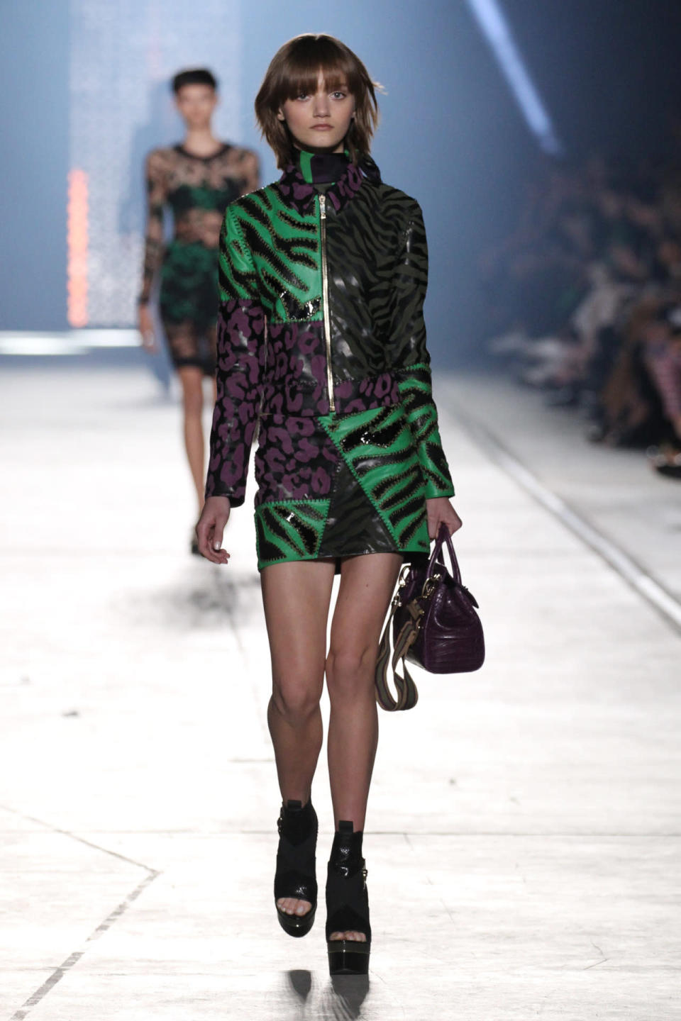 A model wears a matching jacket and miniskirt at Versace’s spring 2016 runway show.
