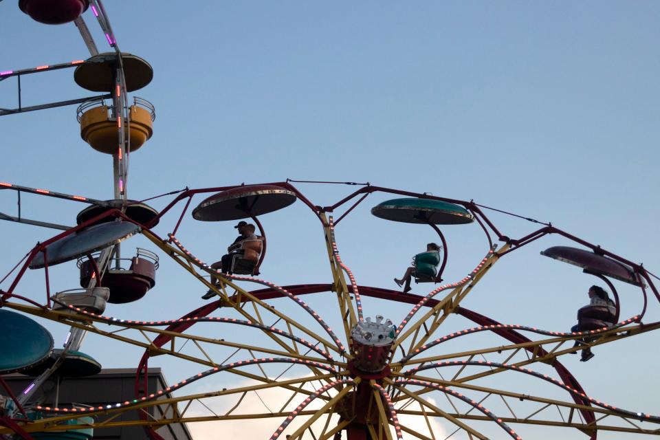 People go around the Paratrooper ride at Carolina Beach Boardwalk's amusement park Thursday, July 25, 2019 in Carolina Beach, N.C. [HALEY FRANCE/STARNEWS]