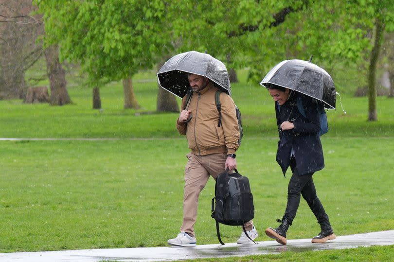 People in Greenwich Park, London, during a rain shower, as parts of the UK are set to be battered by downpours as travellers return home at the end of the Easter weekend. Picture date: Monday April 1, 2024. PA Photo. Photo credit should read: Yui Mok/PA Wire