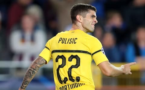 Borussia Dortmund's Christian Pulisic celebrates scoring his side's first goal during a Champions League group A soccer match between Club Brugge and Borussia Dortmund at the Jan Breydel Stadium in Bruges - Credit: AP
