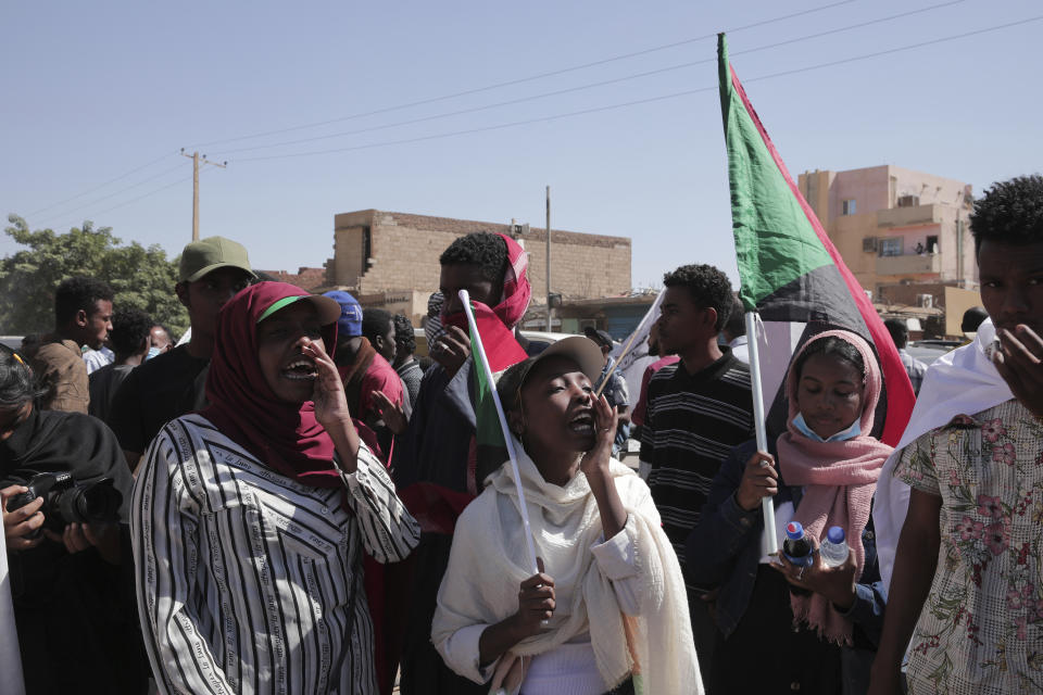 People chant slogans during a protest to denounce the October military coup, in Khartoum, Sudan, Thursday, Dec. 30, 2021. The October military takeover upended a fragile planned transition to democratic rule and led to relentless street demonstrations across Sudan. (AP Photo/Marwan Ali)