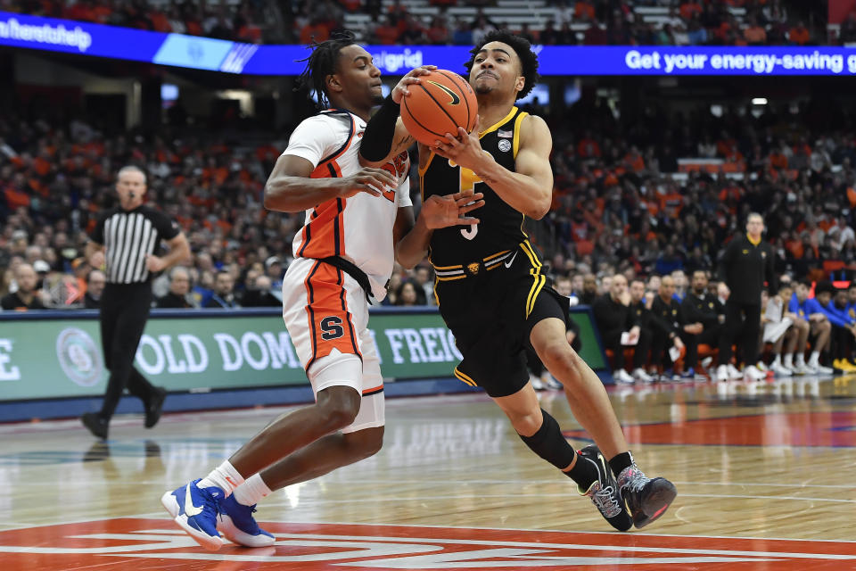 Pittsburgh guard Ishmael Leggett, right, is defended by Syracuse guard J.J. Starling during the first half of an NCAA college basketball game in Syracuse, N.Y., Saturday, Dec. 30, 2023. (AP Photo/Adrian Kraus)