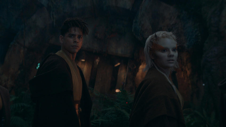 Yord and Jecki look at something behind them in a cave in Star Wars: The Acolyte