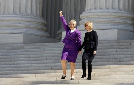 President and CEO of Whole Women's Health Amy Hagstrom Miller (L) holds up her fist as she descends the steps of the U.S. Supreme Court with President and CEO of the Center for Reproductive Rights Nancy Northup after the court took up a major abortion case focusing on whether a Texas law that imposes strict regulations on abortion doctors and clinic buildings interferes with the constitutional right of a woman to end her pregnancy in Washington March 2, 2016. REUTERS/Kevin Lamarque/File Photo