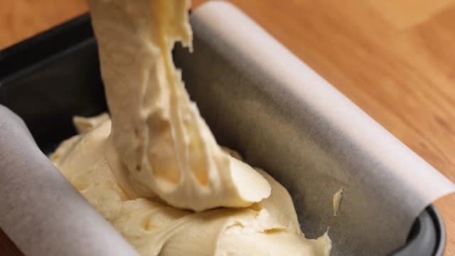 Pouring cake batter into baking tin