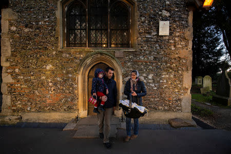 Adi, 37, who works for a removal company, and his wife Maria, 31, along with their daughters, Elena, who is two years and seven-months old, and baby Ioana who is a few weeks old, leave St Andrews church in Kingsbury after attending a service in London, Britain, February 22, 2019. REUTERS/Alecsandra Dragoi