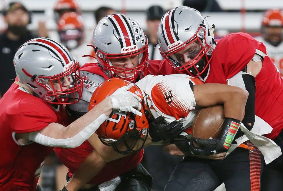 Somers Aidan Coolican (42), George Forbes (52) and Ryan Cole (50) combine to stop Union-Endicott's Cooper Hughes (44) during the state Class A football championships at JMA Wireless Dome in Syracuse Dec. 3, 2022.