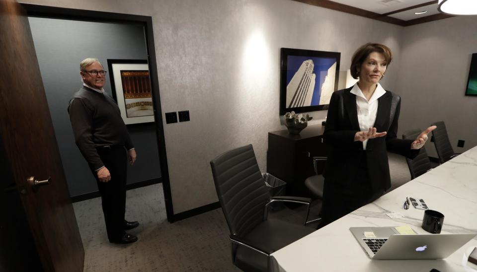 Former Nebraska Lt. Gov. Kim Robak, a Democrat, and her husband, Bill Mueller, a Republican, stand in their office in Lincoln, Neb., on Wednesday, Jan. 4, 2017. The couple, who run a lobbying and government relations firm, says they hope President-elect Donald Trump can break the ideological gridlock in Washington. Though neither was a Trump supporter, they are trying to remain positive about his presidency and even hope it might make hyper-partisan Washington, D.C., a bit more like Lincoln. (AP Photo/Charlie Neibergall)