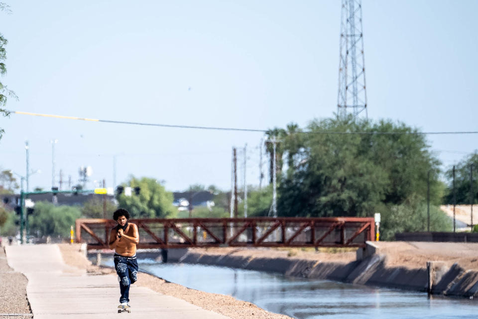 A person skates along the Grand Canal Trail in Phoenix on Aug. 30, 2022. An excessive heat warning was issued by the National Weather Service on Tuesday and remains in effect until Wednesday evening Aug. 31.