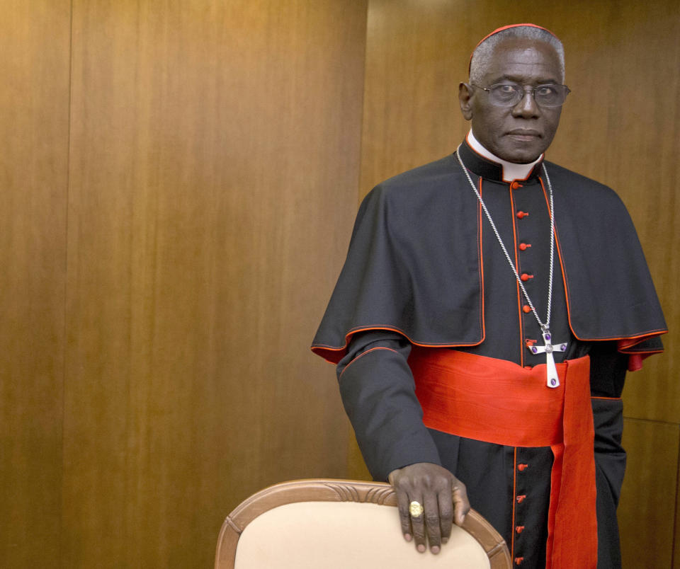 Cardinal Robert Sarah, prefect of the Congregation for Divine Worship and the Discipline of the Sacraments, arrives for the presentation of Cardinal Raymond Leo Burke's book Divine Love Made Flesh, in Rome, Wednesday, Oct. 14, 2015. The Vatican said Saturday it was “necessary and urgent” to return to in-person Masses as soon as coronavirus lockdowns permit. (AP Photo/Andrew Medichini)