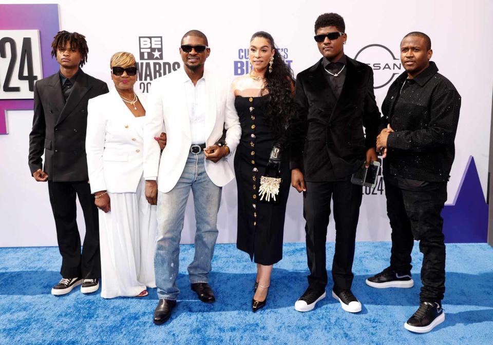 <p>MICHAEL TRAN/AFP via Getty</p> Usher with his wife Jennifer Goicoechea and family at the 2024 BET Awards in Los Angeles.