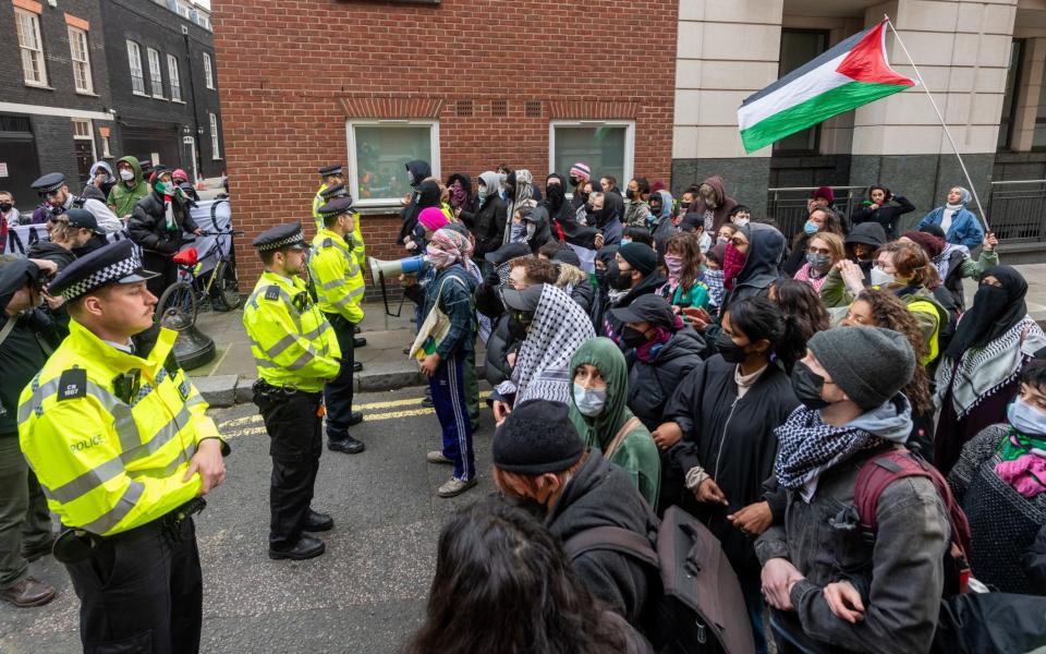 Officers block the path of protesters