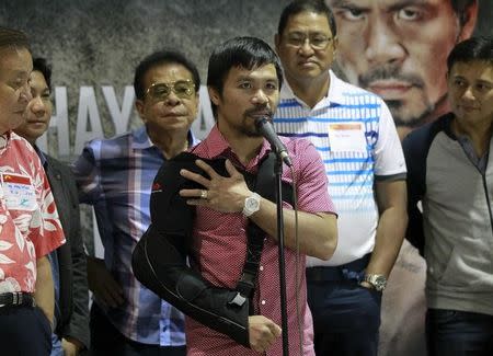 Boxer Manny Pacquiao answer questions during a news conference upon his arrival at the international airport in Manila May 13, 2015. Pacquiao, the former eight-division world champion, lost an unanimous decision to Floyd Mayweather Jr on May 2, 2015 in the richest prize fight ever before undergoing successful arthroscopic surgery on his right shoulder four days later. REUTERS/Romeo Ranoco