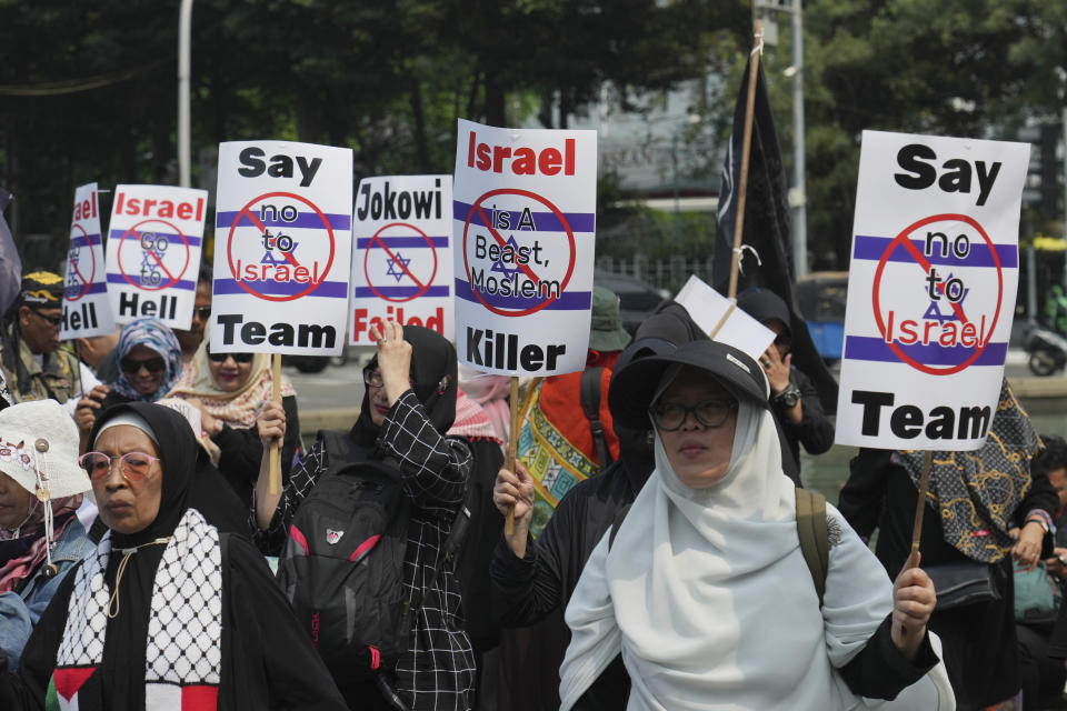 Protesters march during a protest in Jakarta, Indonesia, Monday, March 20, 2023. Hundreds of conservative Muslims have marched to the streets Monday in Indonesia's capital to protest against the Israeli team's participation in the FIFA World Cup Under-20 in Indonesia.(AP Photo/Achmad Ibrahim)