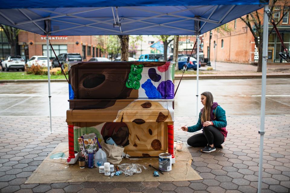 Anna Berman paints a piano with a dessert-themed design in Old Town on Thursday, May 11, 2023, in Fort Collins.