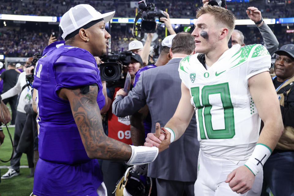 LAS VEGAS, NEVADA - DECEMBER 01: Michael Penix Jr. #9 of the Washington Huskies and Bo Nix #10 of the Oregon Ducks shake hands after Washington's win 34-31 during the Pac-12 Championship at Allegiant Stadium on December 01, 2023 in Las Vegas, Nevada. (Photo by Ian Maule/Getty Images)