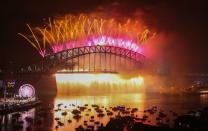 <p>Fireworks explode from the Sydney Harbour Bridge and the Sydney Opera House during the midnight fireworks display on New Year’s Eve on New Year’s Eve on January 1, 2018 in Sydney, Australia. (Photo: Scott Barbour/Getty Images) </p>