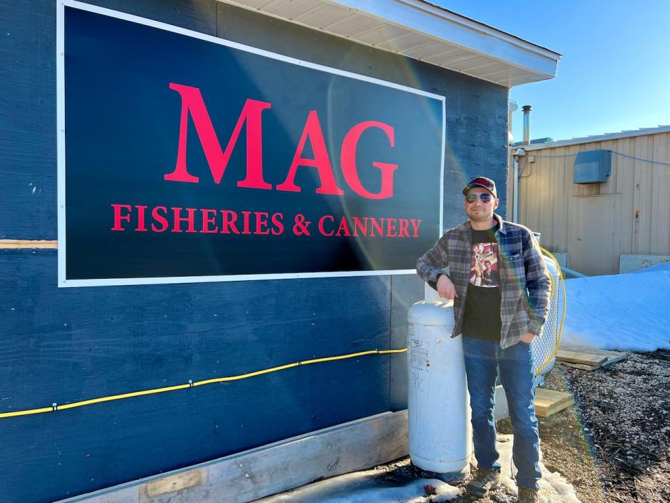 Campbell in front of MAG Fisheries & Cannery, he would like to see the business grow into a full-time career for him so he can spend more time at home with his family. 