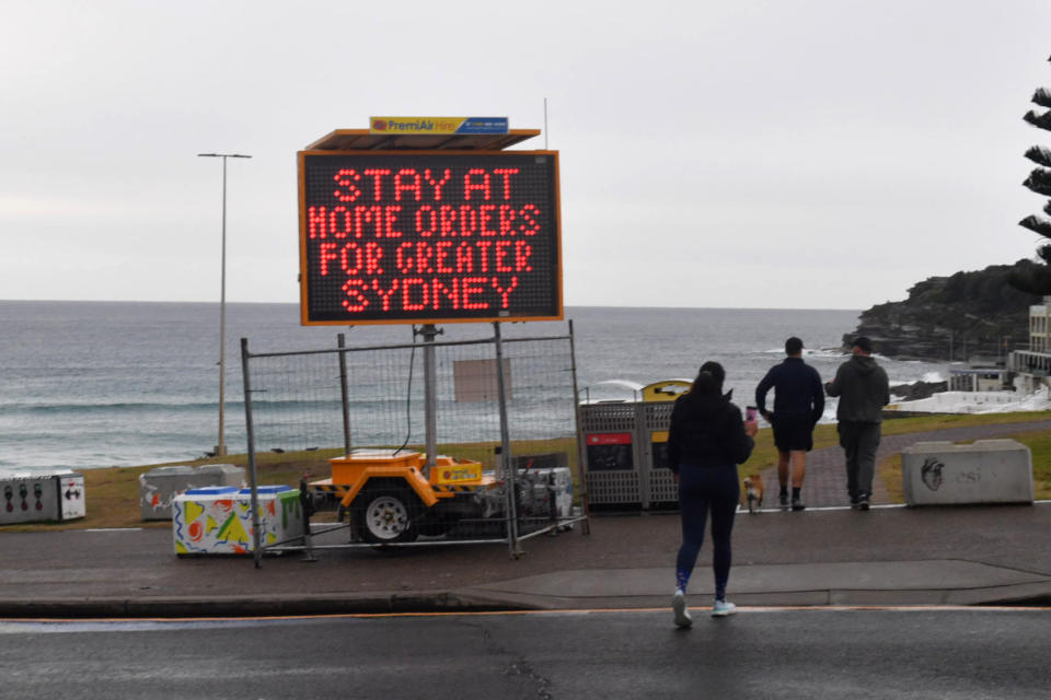 A Covid warning sign is seen at Bondi Beach in Sydney.