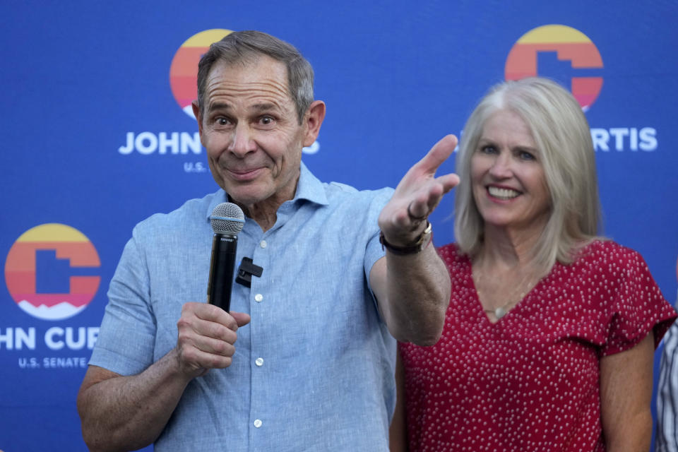 U.S. Rep. John Curtis addresses supporters as his wife Sue looks on after his win during an election night party, Tuesday, June 25, 2024, in Provo, Utah. Curtis has won the Utah GOP primary for Mitt Romney's open U.S. Senate seat, defeating one opponent who was endorsed by former President Donald Trump and others who said they supported Trump's agenda. (AP Photo/Rick Bowmer)