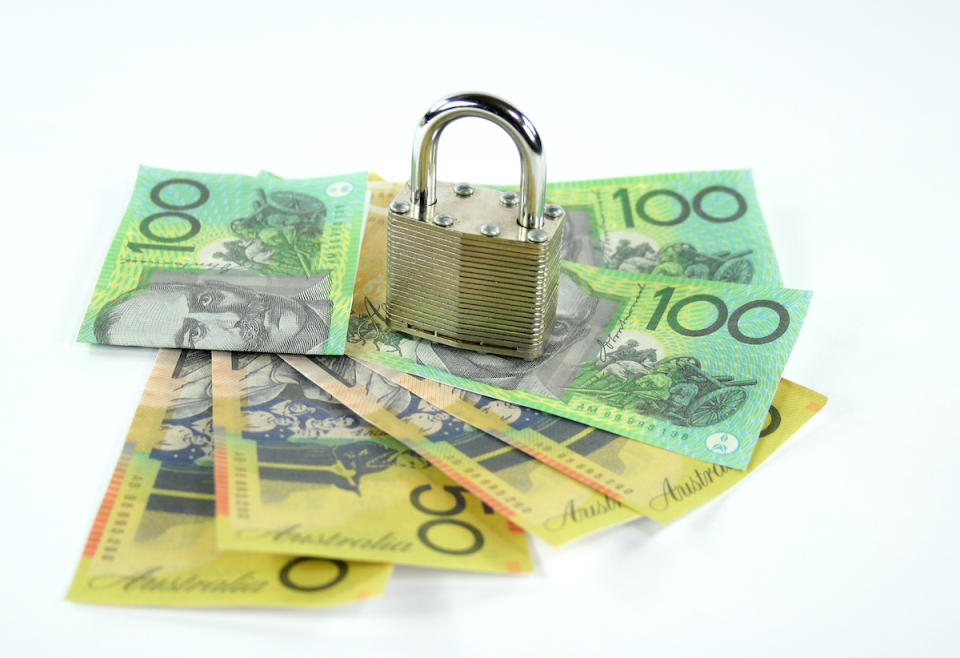 Closed padlock with australian dollar notes.