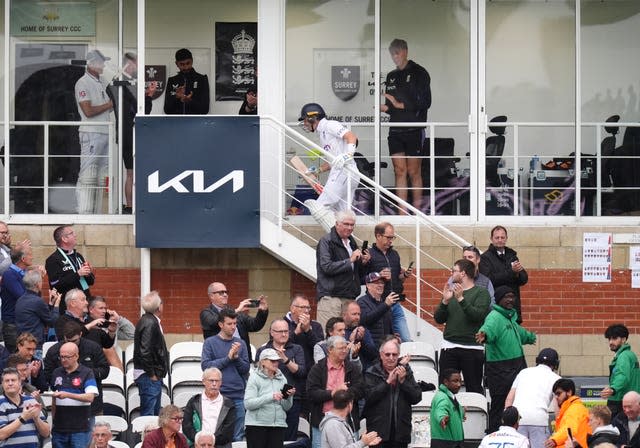 England’s Ollie Pope, top, takes the applause of the crowd as the players head off for bad light 