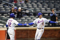 New York Mets' Brandon Nimmo (9) celebrates with teammate Francisco Lindor (12) after hitting a home run during the fourth inning in the first baseball game of a doubleheader against the Washington Nationals, Tuesday, Oct. 4, 2022, in New York. (AP Photo/Frank Franklin II)