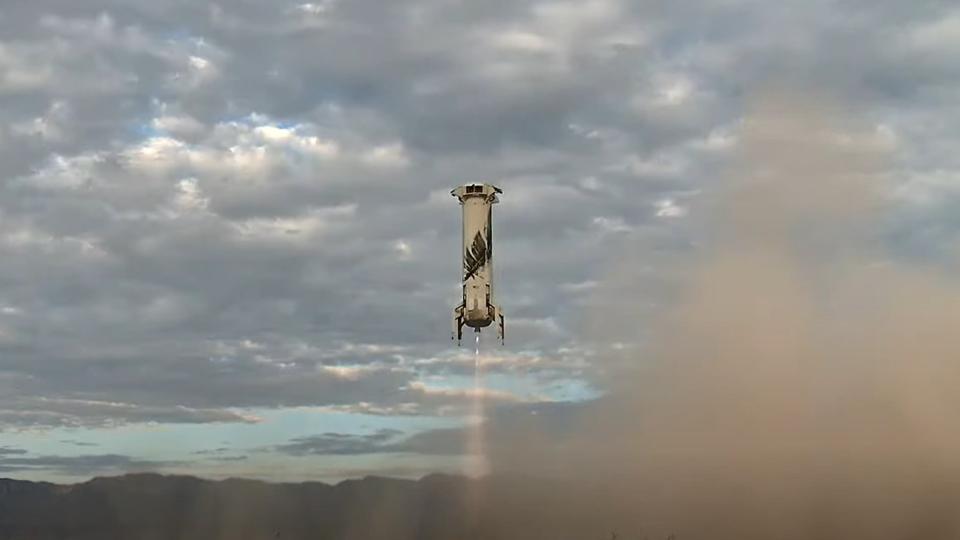 a rocket comes down for a landing above a dusty desert