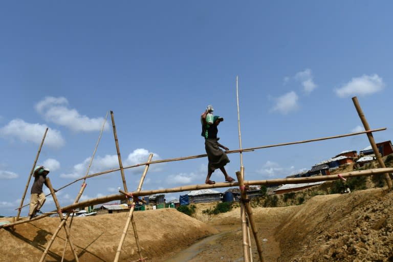 Rohingya refugees carry sandbags in preparation for the upcoming monsoon season in Kutupalong refugee camp