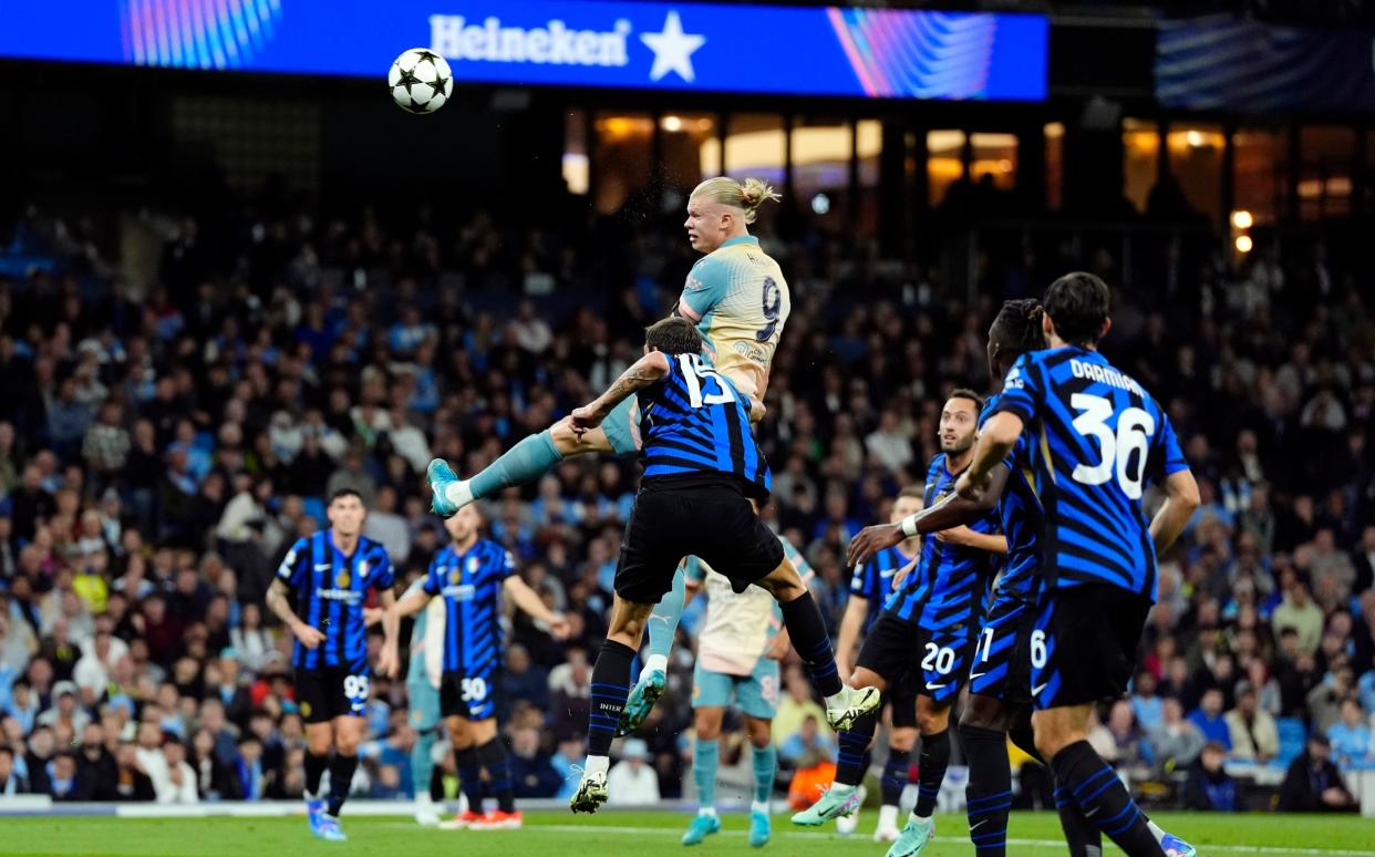 Manchester City's Erling Haaland heads at goal during