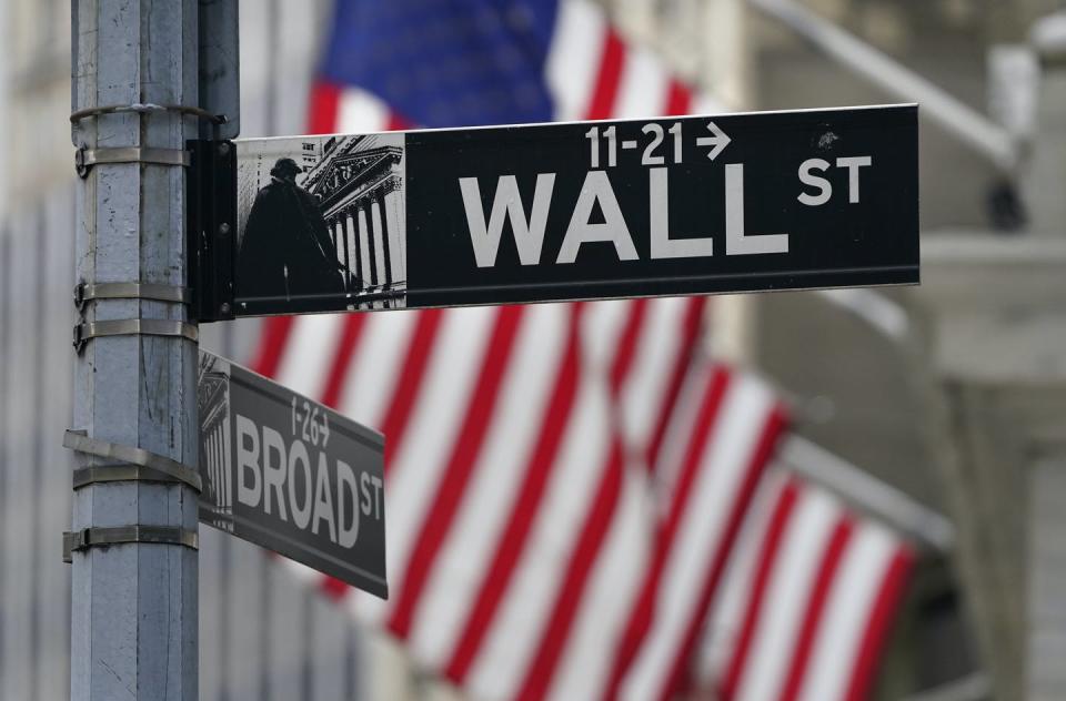 <span class="caption">A street sign is displayed at the New York Stock Exchange in New York.</span> <span class="attribution"><span class="source">(AP Photo/Seth Wenig)</span></span>