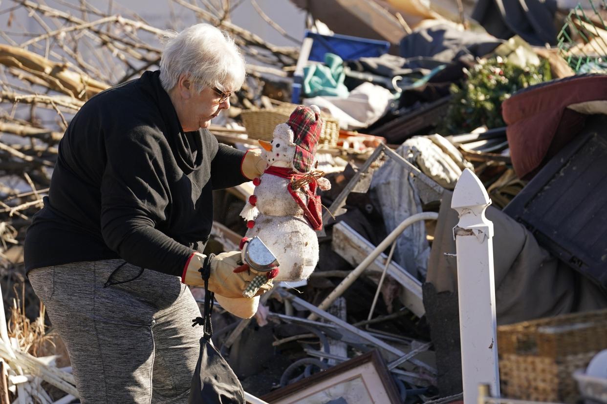 Martha Thomas of Mayfield, Kentucky, salvages Christmas decorations from her destroyed home in the aftermath of tornadoes that tore through the Midwest on Dec. 10 and 11. (AP Photo/Gerald Herbert)