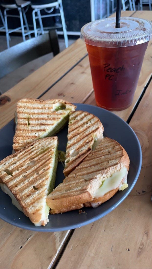 A pesto provolone sandwich on gluten-free bread and iced tea from The Black Sheep in Glendale, Arizona on March 21, 2023.