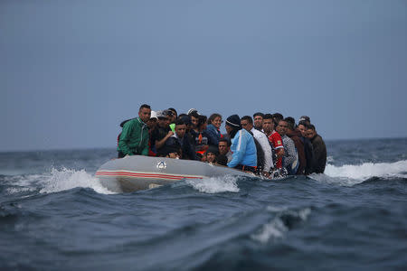 Migrants are seen before disembarking from a dinghy at Del Canuelo beach as they cross the Strait of Gibraltar sailing from the coast of Morocco, in Tarifa, southern Spain, July 27, 2018. REUTERS/Jon Nazca