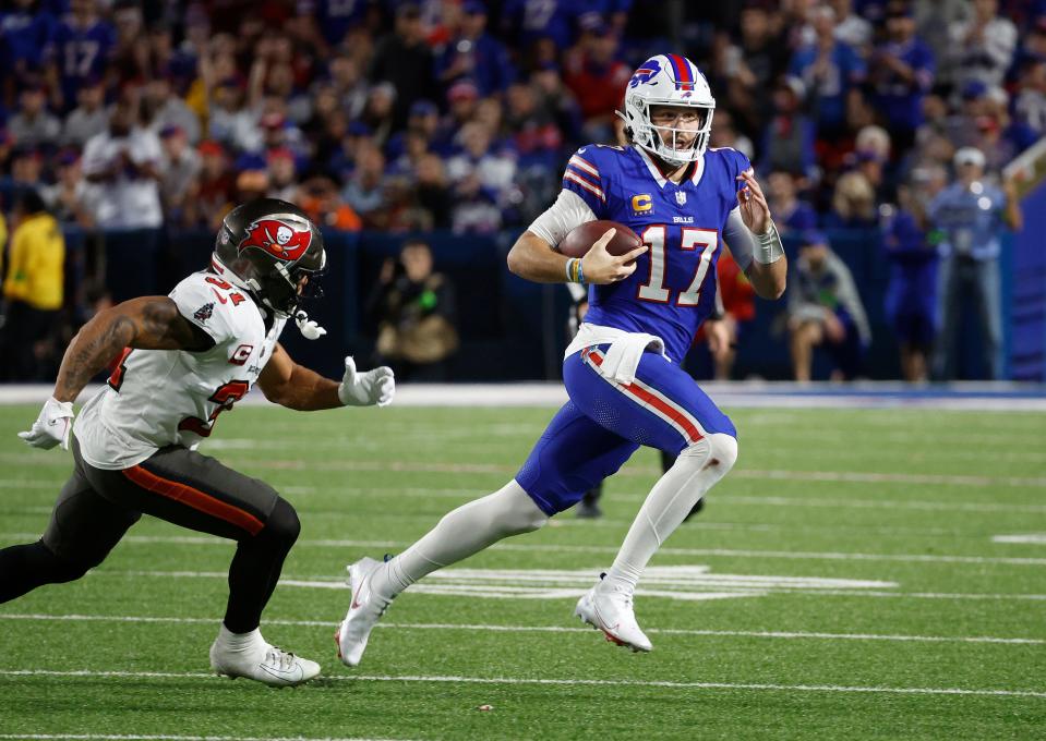 Buffalo Bills quarterback Josh Allen (17) runs toward the sideline against Tampa Bay Buccaneers safety Antoine Winfield Jr. (31).