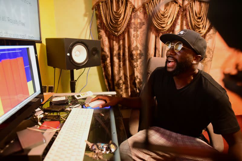 Sierra Leonean musician Emmerson Bockarie sings along to one of his songs at a studio in Freetown