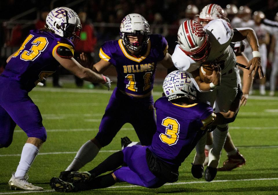 Bloom-Carroll's Jett Jones makes a tackle while teammates Andrew Marshall and Tristan Britch close in during the Bulldogs' 35-12 Division III state semifinal win over Tippecanoe. The Bulldogs will play for a state championship on Friday against Canfield.